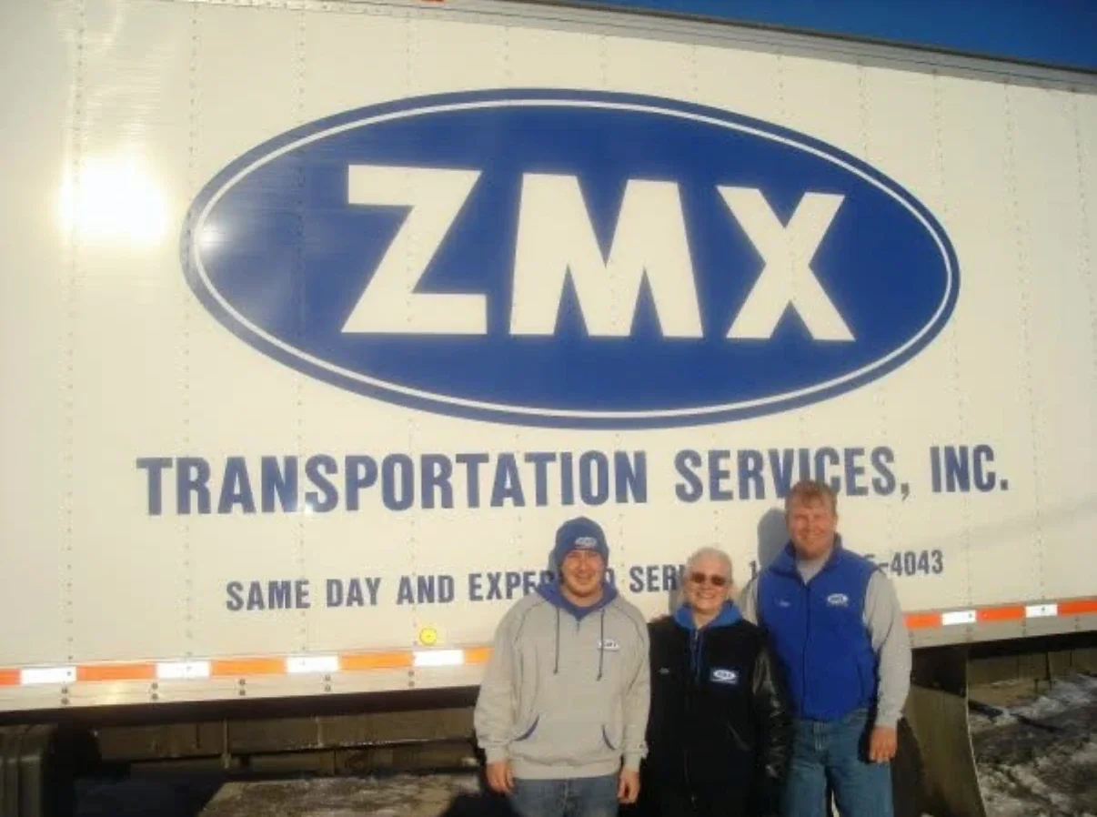 The ZMX family standing in front of a ZMX trailer